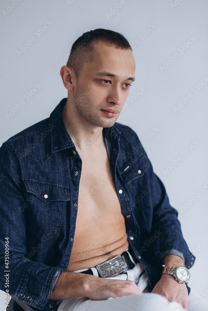 Fototapeta premium Handsome young man model in studio on isolated background