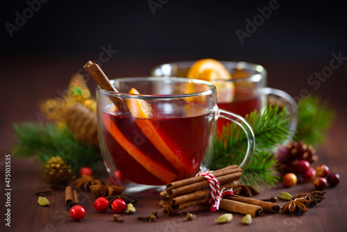 Christmas mulled red wine with spices and fruits on a wooden rustic table. Traditional drink on winter holiday
