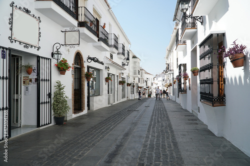 Village alley with white walls and stone street © Mery_Stockera
