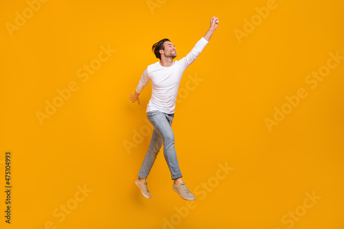 Fotografie Full length photo of impressed brunet millennial guy run wear shirt jeans shoes
