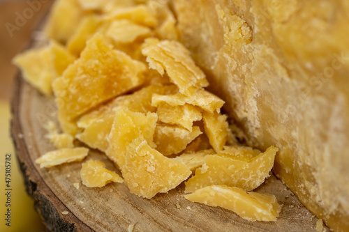 Piece of Parmesan cheese and cheese on the wooden board