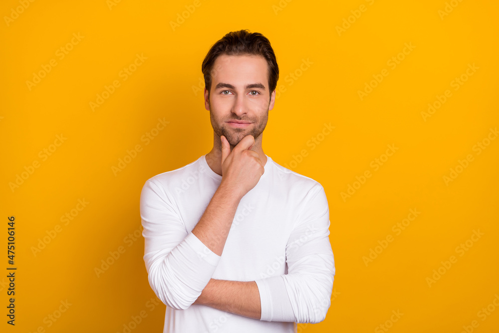 Photo of calm confident minded person arm touch chin look camera isolated on yellow color background Photo of calm confident minded person arm touch chin look camera isolated on yellow color background
