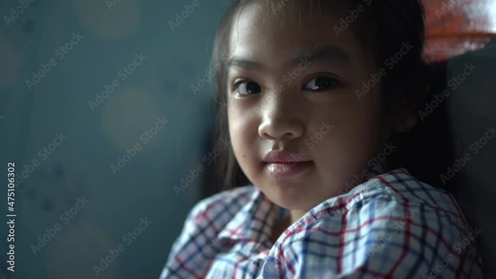 Close up portrait of Young asian little girl looking ahead and smile to camera Close up portrait of Young asian little girl looking ahead and smile to camera