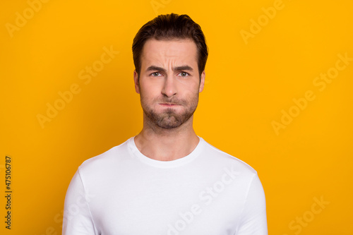 Photo of youngster man pouted cheeks grimace hold breath humorous isolated over yellow color background