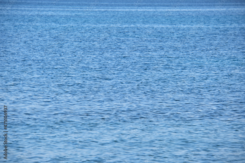 Obraz premium Closeup seascape surface of blue sea water with small ripple waves