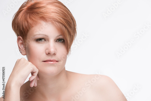 Portrait of a seriously looking young red haired woman