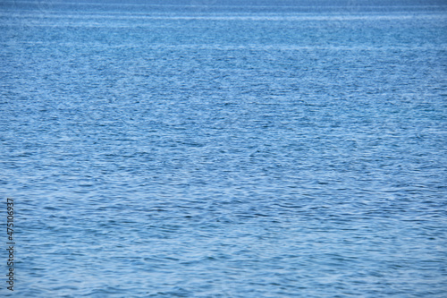 Closeup seascape surface of blue sea water with small ripple waves