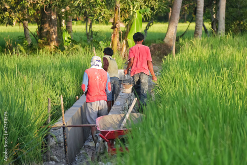 installation of irrigation canals for rice fields in a village