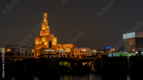 view of doha corniche during night along with fanar building.