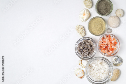 Various types of salt crystals, powder of sea minerals in glass bowls