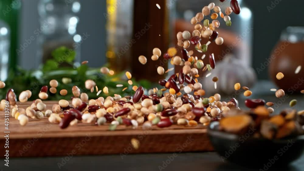 Super slow motion of rolling  legumes mix on wooden board. Filmed on high speed cinema camera , 1000 fps. Camera in motion control, follow the object.