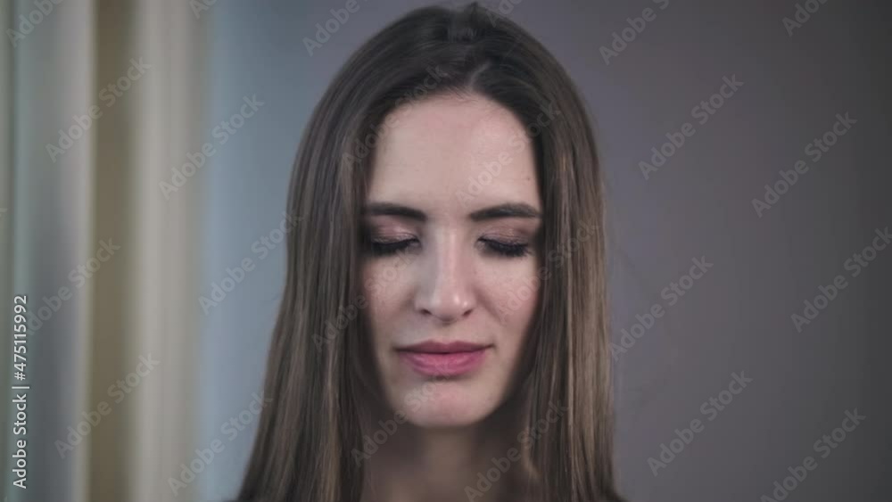Front Closeup Portrait Of Young Woman Looking Friendly At Camera. Human Face, Natural Make Up Young Woman Opens Her Eyes Slow Motion Front Closeup Portrait Of Young Woman Looking Friendly At Camera. Human Face, Natural Make Up Young Woman Opens Her Eyes Slow Motion