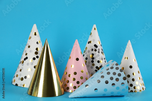 Bright party hats on light blue background