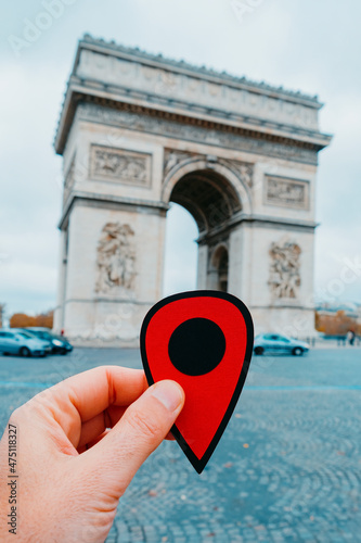 man with red marker at the Arc de Triomph in Paris