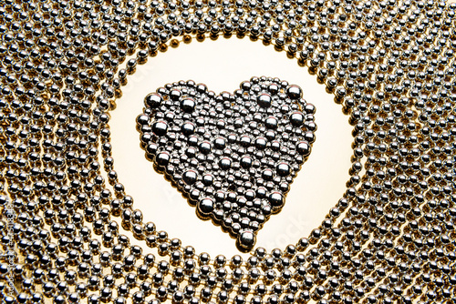 Ornament in the shape of a heart made of shiny balls. Love symbol.