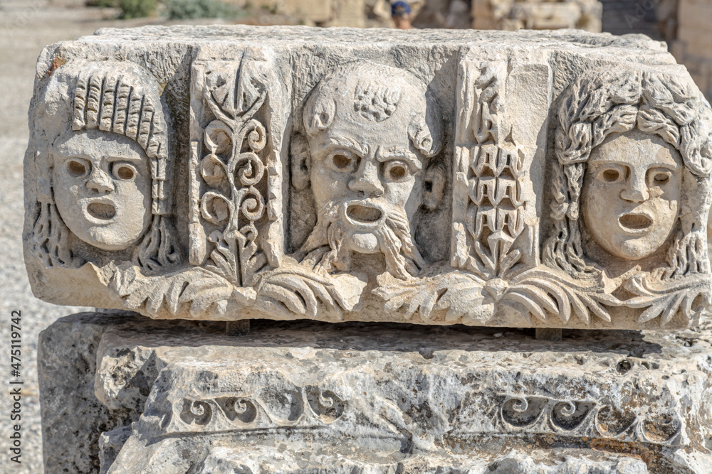 Ancient greek stone carvings in the yellow limestone rock. Facade of the building decoration in antique style