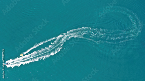 Aerial drone photo of extreme powerboat donut water-sports cruising in high speed in tropical turquoise bay © aerial-drone