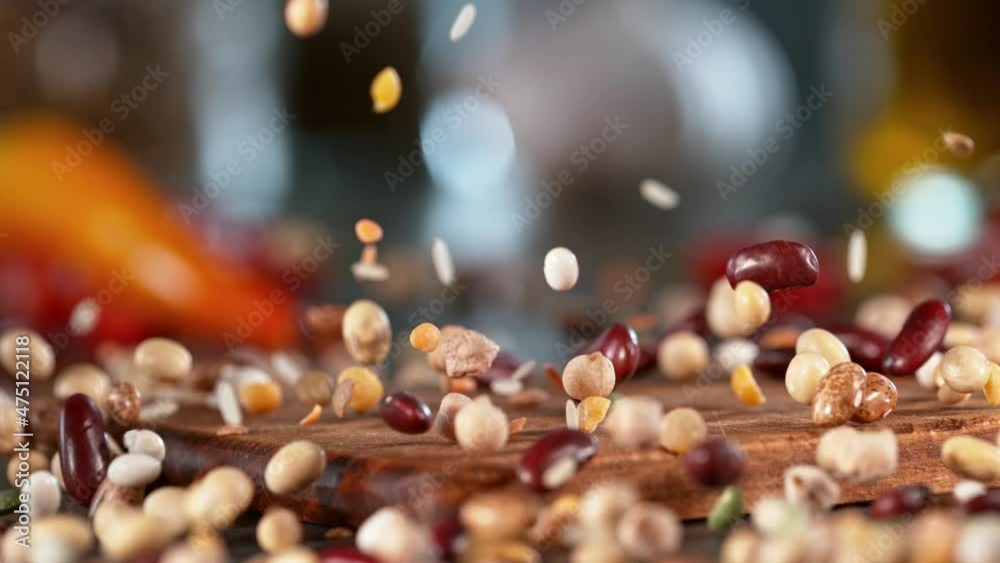 Super slow motion of falling legumes mix on wooden board. Filmed on high speed cinema camera , 1000 fps. Camera in motion control, follow the object. Speed ramp effect. Super slow motion of falling legumes mix on wooden board. Filmed on high speed cinema camera , 1000 fps. Camera in motion control, follow the object. Speed ramp effect.