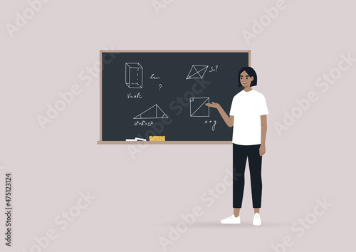 A young school teacher explains Geometry by pointing on the blackboard with hand-drawn figures