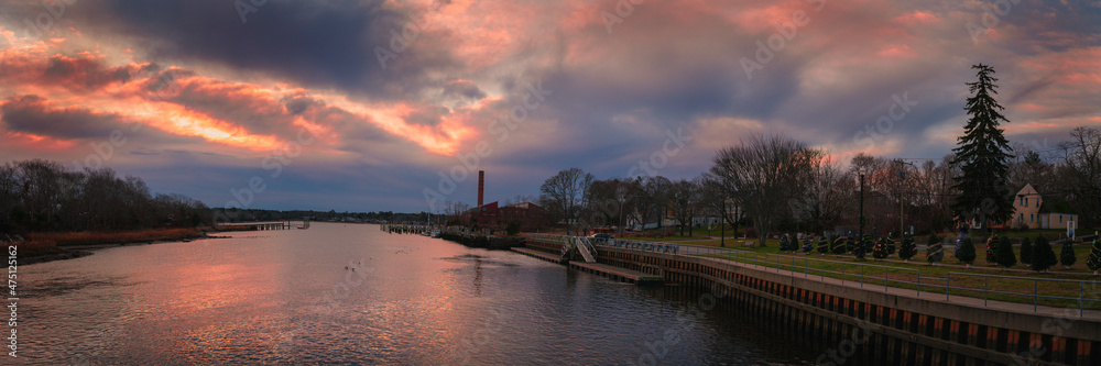 Dramatic cloudscape at sunrise over the coastal village and canal in Wareham, Massachusetts.