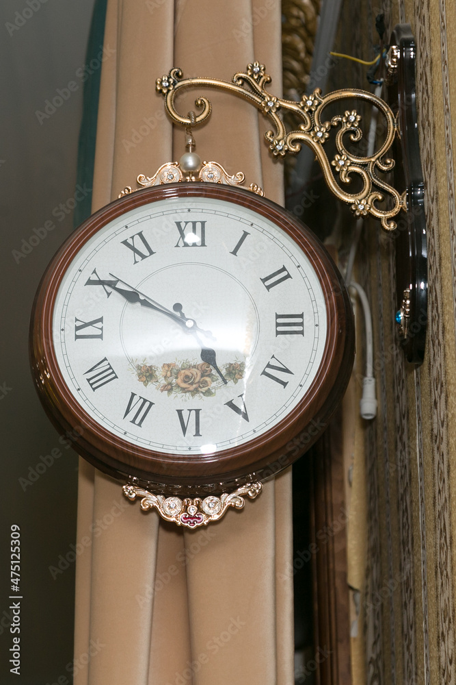 Large round wall clock in a brown frame in a restaurant. Large round wall clock in a brown frame in a restaurant.