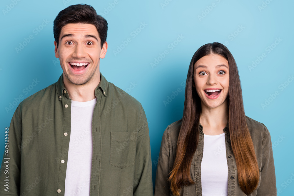 Photo of impressed spouses lady guy hear incredible novelty scream isolated over blue color background Photo of impressed spouses lady guy hear incredible novelty scream isolated over blue color background