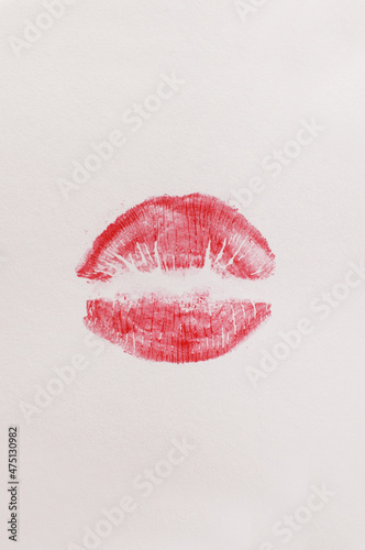 a trace of red lipstick on a white background in vertical format