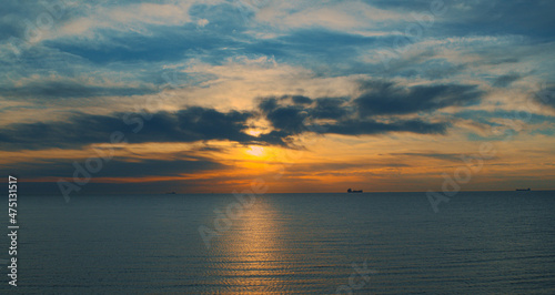 Charming orange sunrise reflecting in sea waves. Delightful seascape view. © stockbusters