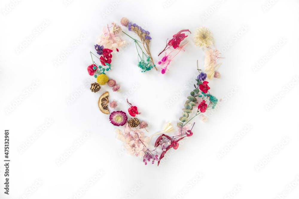 fresh colorful spring flowers in shape of heart isolated on white bright background, flat lay, top view. Spring concept. Pattern romantic heart symbol fresh colorful spring flowers in shape of heart isolated on white bright background, flat lay, top view. Spring concept. Pattern romantic heart symbol