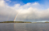 Double Rainbow in the cloudy sky over the pacific ocean and Gulf Islands in Background. West Coast in Vancouver Island, British Columbia, Canada. Nature Background
