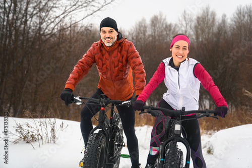 Couple Mountain Biking on Fat Bikes in the winter