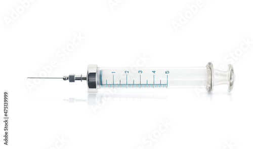 glass syringe with a needle isolated on white background with shadow and reflection