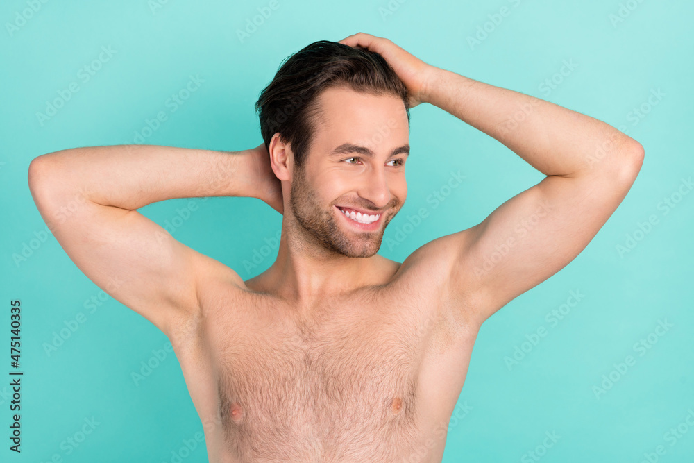 Photo of attractive positive guy hands touch hair look empty space isolated on turquoise color background