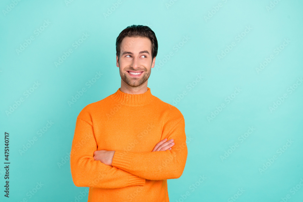 Photo of young man wonder look empty space idea minded crossed hands isolated over teal color background Photo of young man wonder look empty space idea minded crossed hands isolated over teal color background