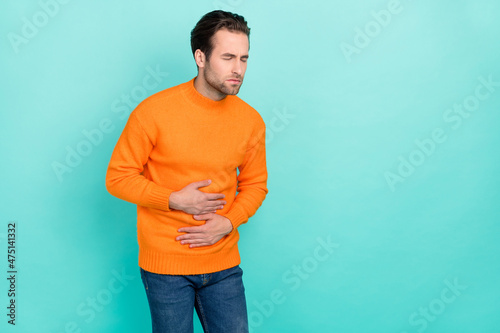 Fotografi Portrait of unsatisfied person arm on stomach closed eyes feel bad isolated on t