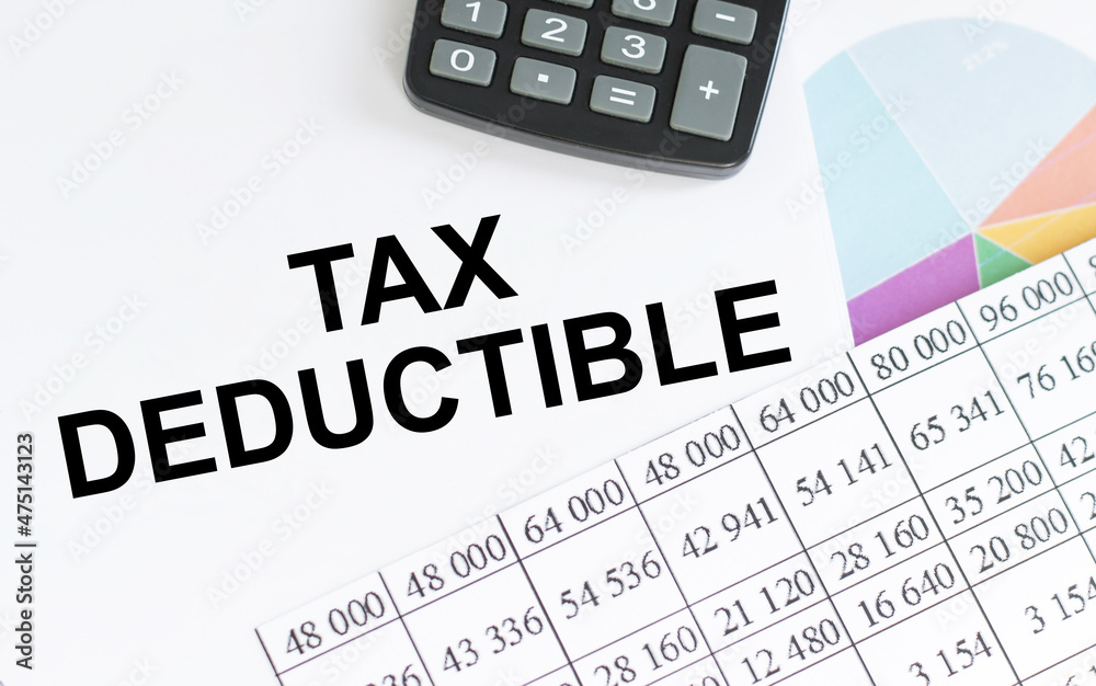 Notebook with text TAX DEDUCTIONS . Diagram and white background,Business