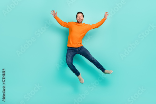 Full length photo of cheerful overjoyed person flying have fun isolated on turquoise color background