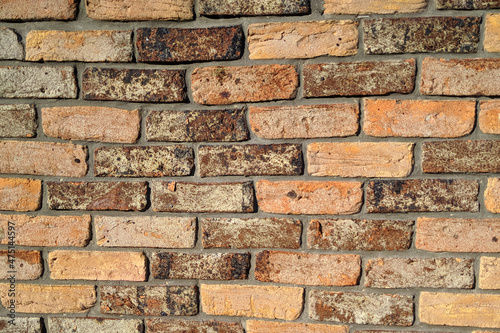 Loft style wall, texture of old multicolored shabby ceramic brick wall