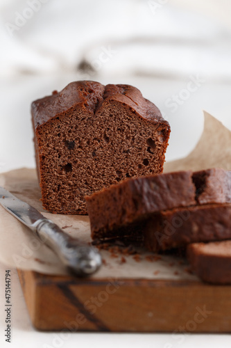 Homemade freshly baked chocolate pound cake loaf. Delicious homemade dessert. Slices on a cutting board. Selective focus, copy space