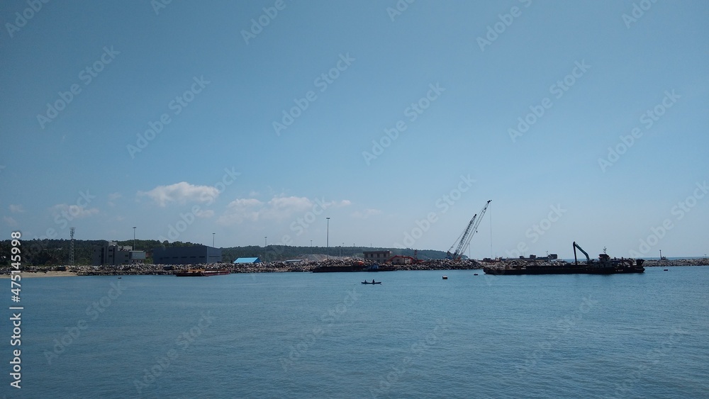 Vizhinjam sea port, Thiruvananthapuram, Kerala, seascape view, blue sky background
