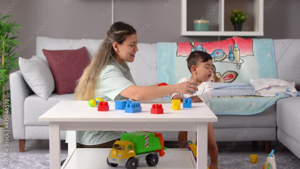 Mother and baby play. The mother is playing with her baby boy. The mother throws the ball up and the child laughs.
Mother and baby play. The mother is playing with her baby boy. The mother throws the ball up and the child laughs.