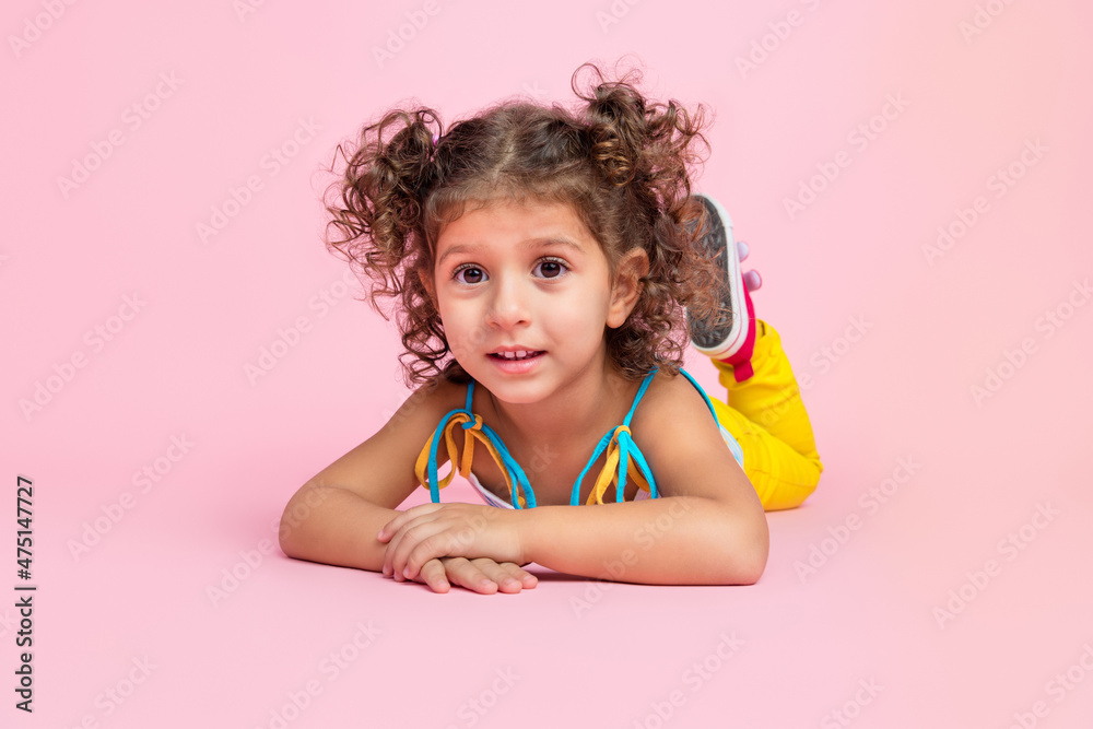 Portrait of attractive cheerful wavy-haired girl lying on floor resting summer time isolated over pink pastel color background Portrait of attractive cheerful wavy-haired girl lying on floor resting summer time isolated over pink pastel color background