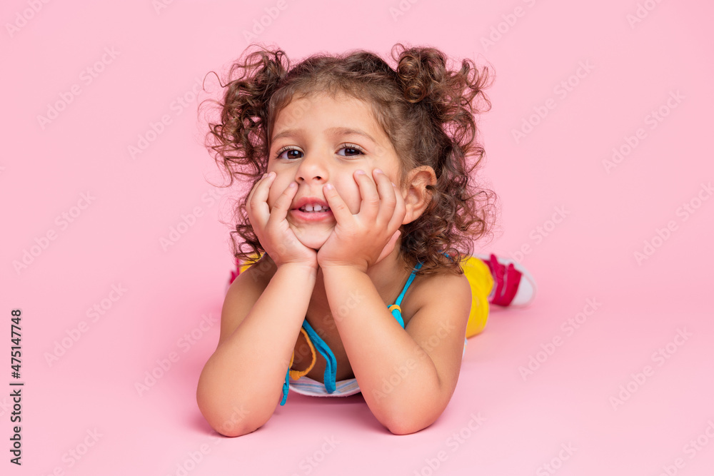 Portrait of attractive cute wavy-haired girl lying on floor resting spending day weekend isolated over pink pastel color background Portrait of attractive cute wavy-haired girl lying on floor resting spending day weekend isolated over pink pastel color background