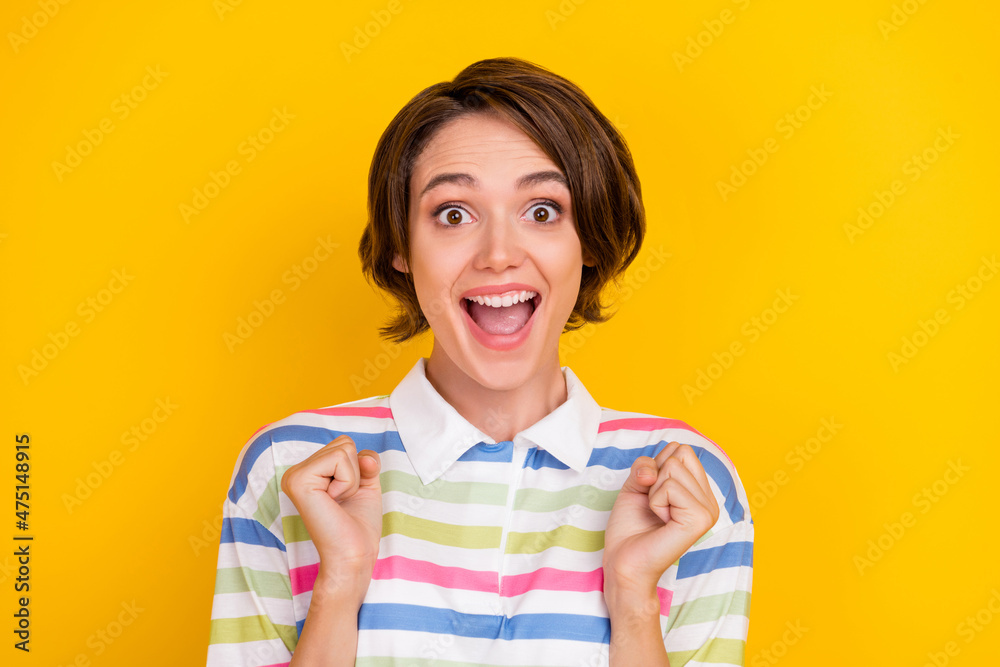Photo of funny millennial brunette lady hands fists wear white t-shirt isolated on yellow color background Photo of funny millennial brunette lady hands fists wear white t-shirt isolated on yellow color background