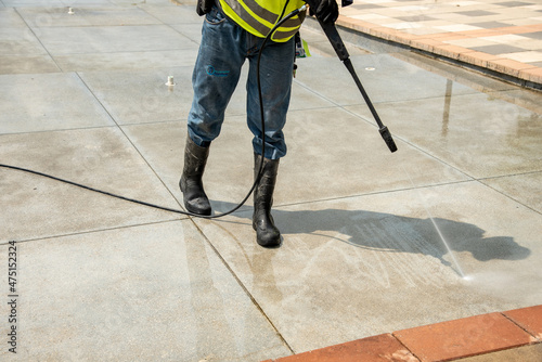 Floor cleaning with high pressure gun, boots equipped for the job