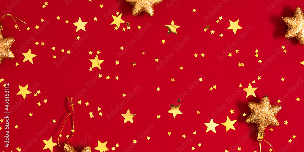 Gold stars on red background. Festive red background with gold stars confetti. Flat lay, top view, copy space Gold stars on red background. Festive red background with gold stars confetti. Flat lay, top view, copy space