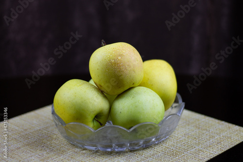 Fresh autumn yellow apples on a plate