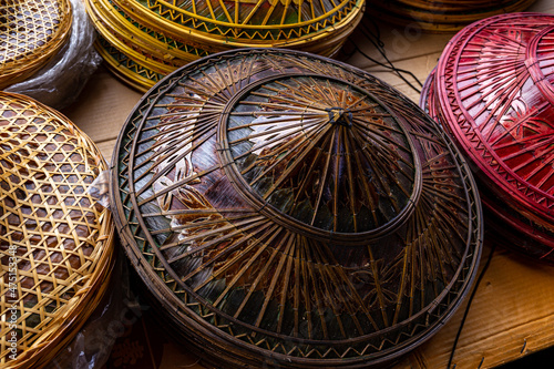 Traditional Chinese hats (Guilor hats) and many Asian hats made from beautifully woven bamboo and painted for sale to tourists as souvenirs. In Damnoen Saduak floating market community 