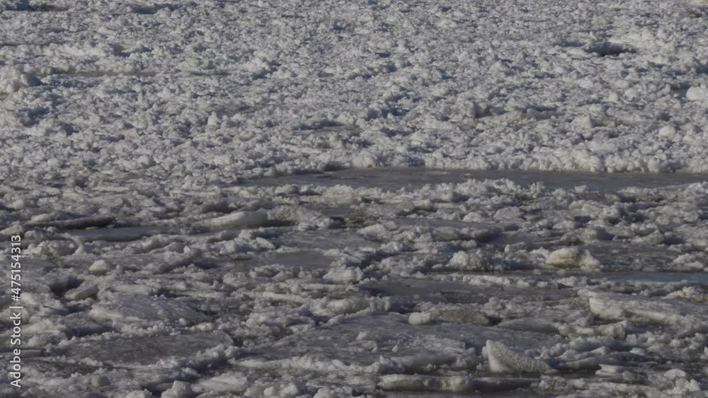 ice with snow floats on the sea waves ice with snow floats on the sea waves