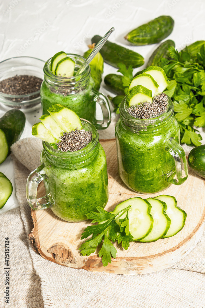 Green smoothie with cucumber in a glass jar. Fresh ripe vegetables, greens, and chia seeds Green smoothie with cucumber in a glass jar. Fresh ripe vegetables, greens, and chia seeds
